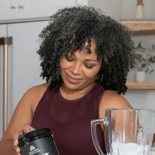 woman blending Ancient Nutrition Bone Broth Protein